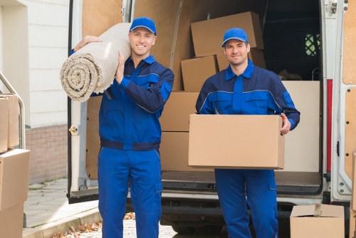 Local movers handling boxes and furniture in a Roehampton home