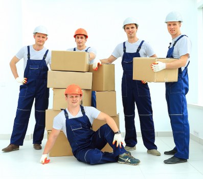 Mover carrying furniture through a property during relocation