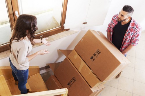 Removal crew carrying boxes safely during a house move