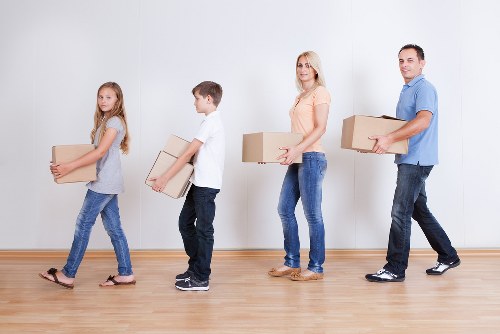 Professional movers handling desks and office furniture during a Roehampton relocation