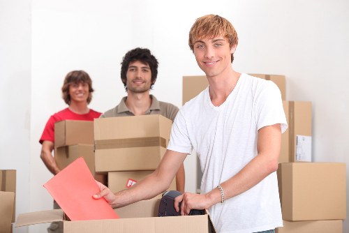 Professional movers in Roehampton loading items securely into a removal vehicle