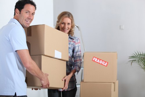 Removal team carrying furniture at a Roehampton property